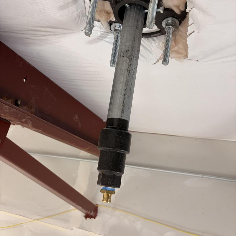 Roof hydrant installation with metal piping and fixture