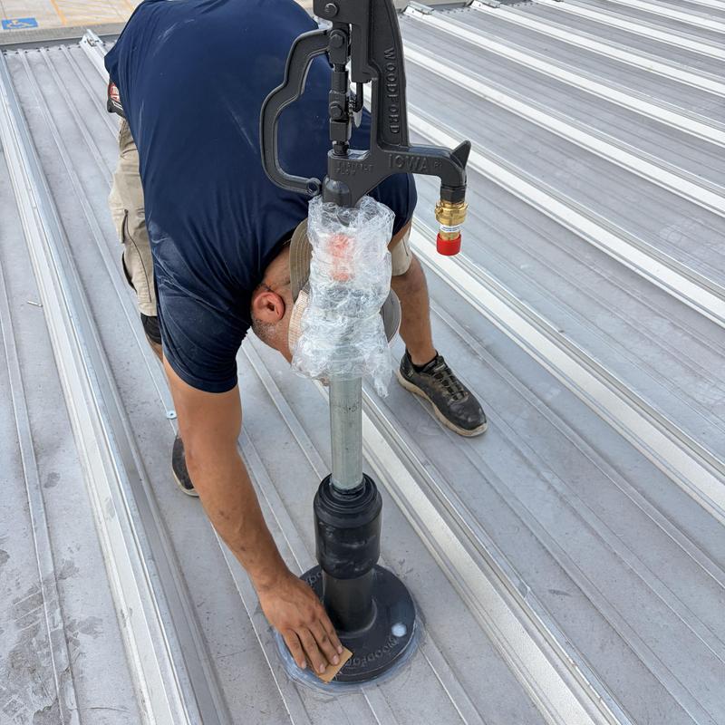 Roof hydrant installation on metal roof panels
