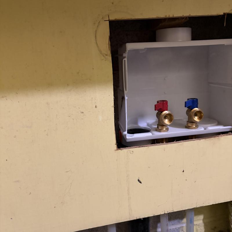 Washer box with red and blue valves installed in wall Washer box with red and blue valves installed in wall