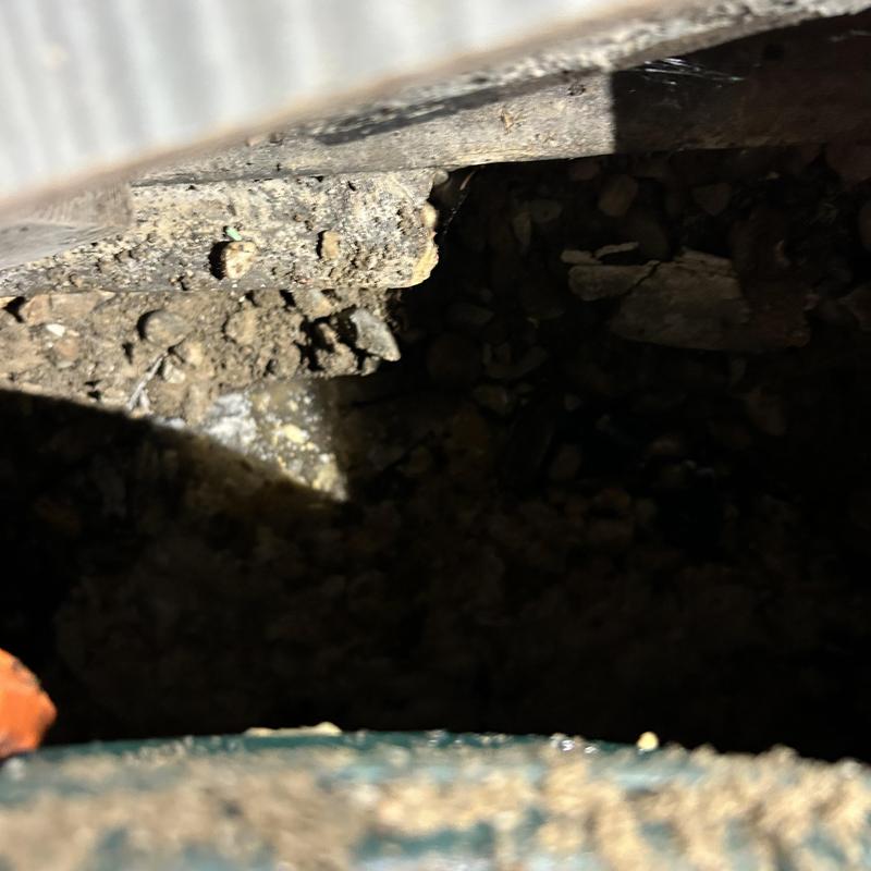 Septic tank opening with soil and debris inside Septic tank opening with soil and debris inside