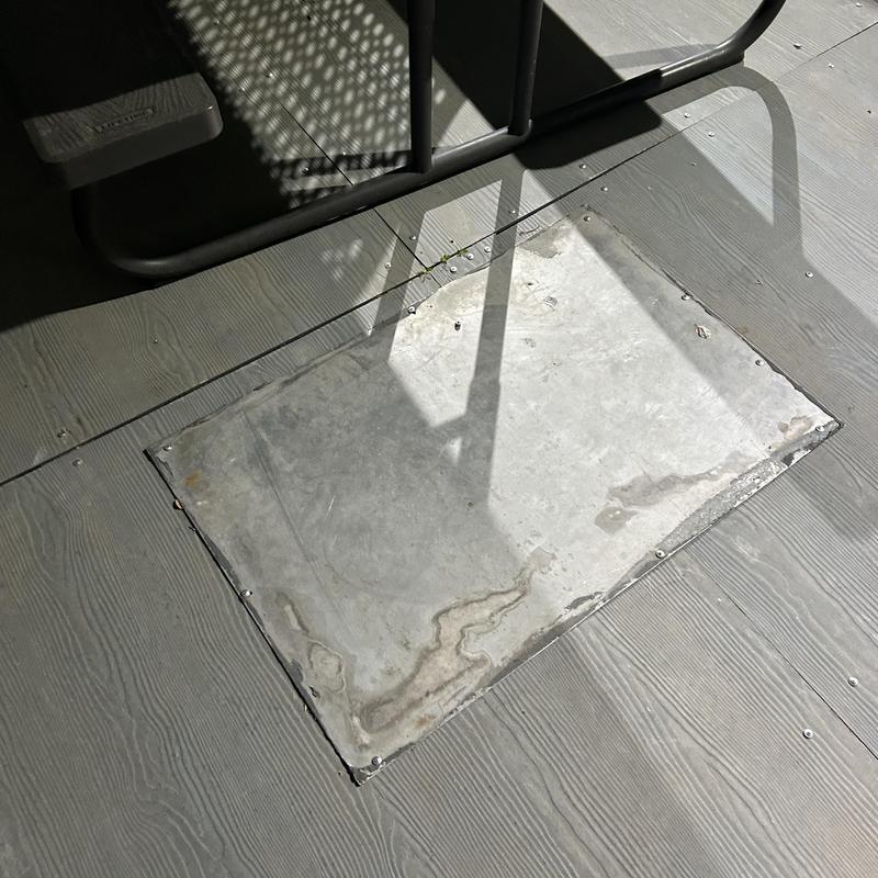 Septic tank access hatch on wooden deck Septic tank access hatch on wooden deck