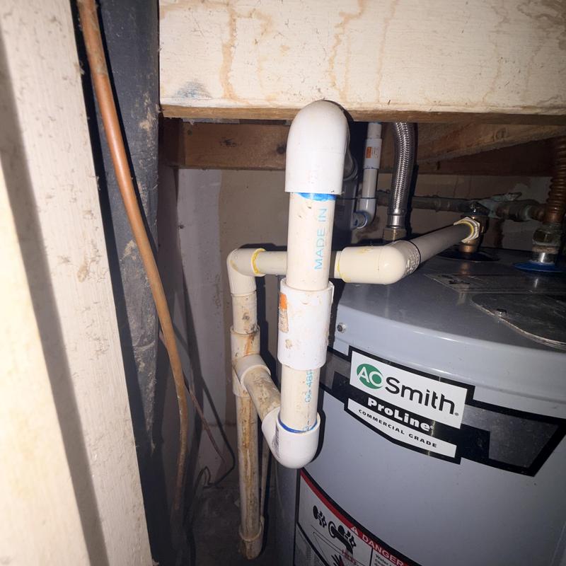 Water heater PVC vent piping installation in utility closet Water heater PVC vent piping installation in utility closet