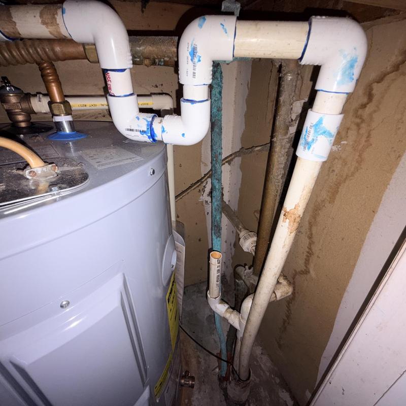 Water heater plumbing and PVC pipe connections in utility room Water heater plumbing and PVC pipe connections in utility room