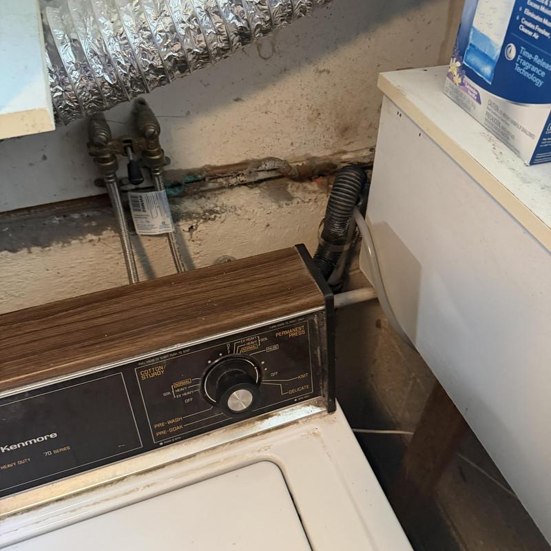 Laundry water supply valves and dryer vent hose in laundry room Laundry water supply valves and dryer vent hose in laundry room