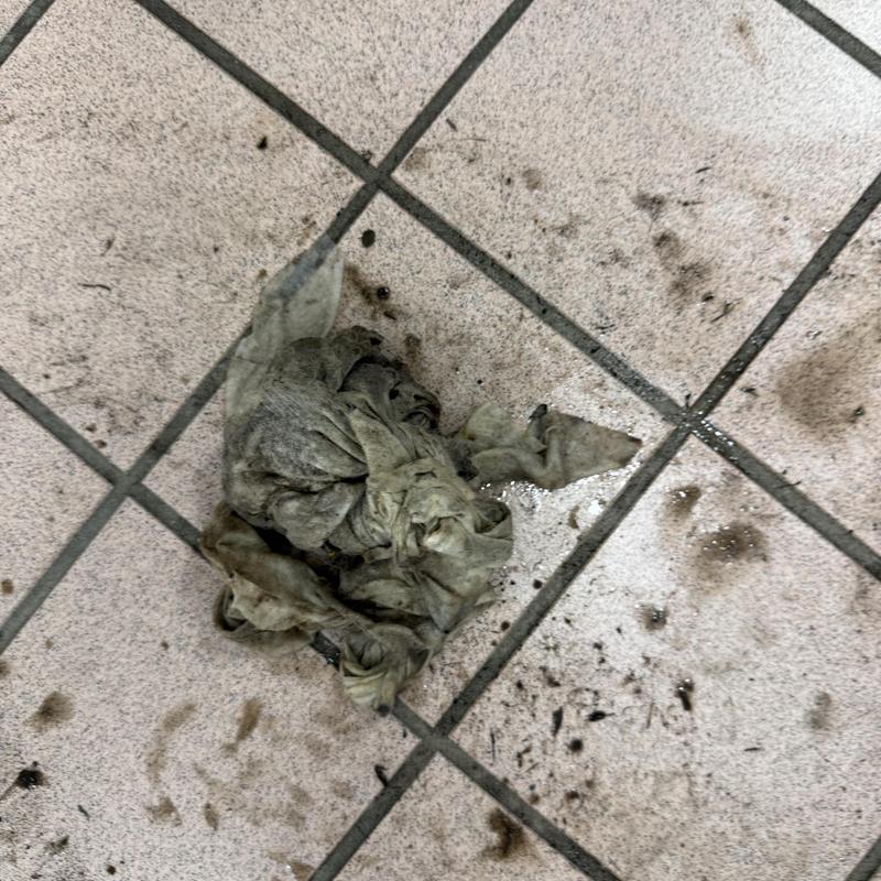 Commercial main line cleaning debris on tiled floor Commercial main line cleaning debris on tiled floor