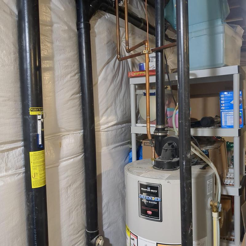 Bradford White water heater with copper piping and radon pipes