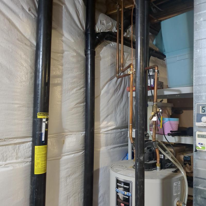 Bradford White water heater with copper and PVC pipes