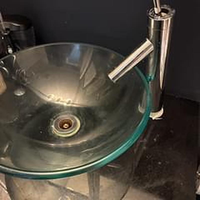 Glass lavatory sink with modern faucet installation