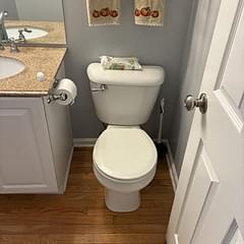 Toilet with new wax ring installed in bathroom