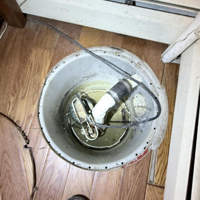 Sump pump with check valve installed in basement floor Sump pump with check valve installed in basement floor