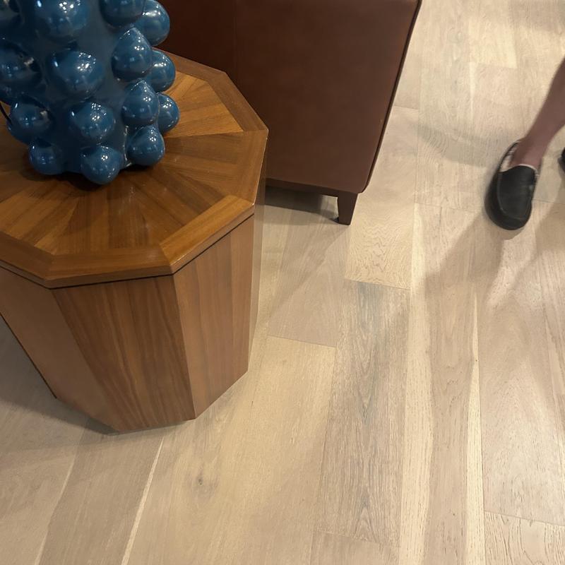 Floor outlet installation near wooden table and couch Floor outlet installation near wooden table and couch
