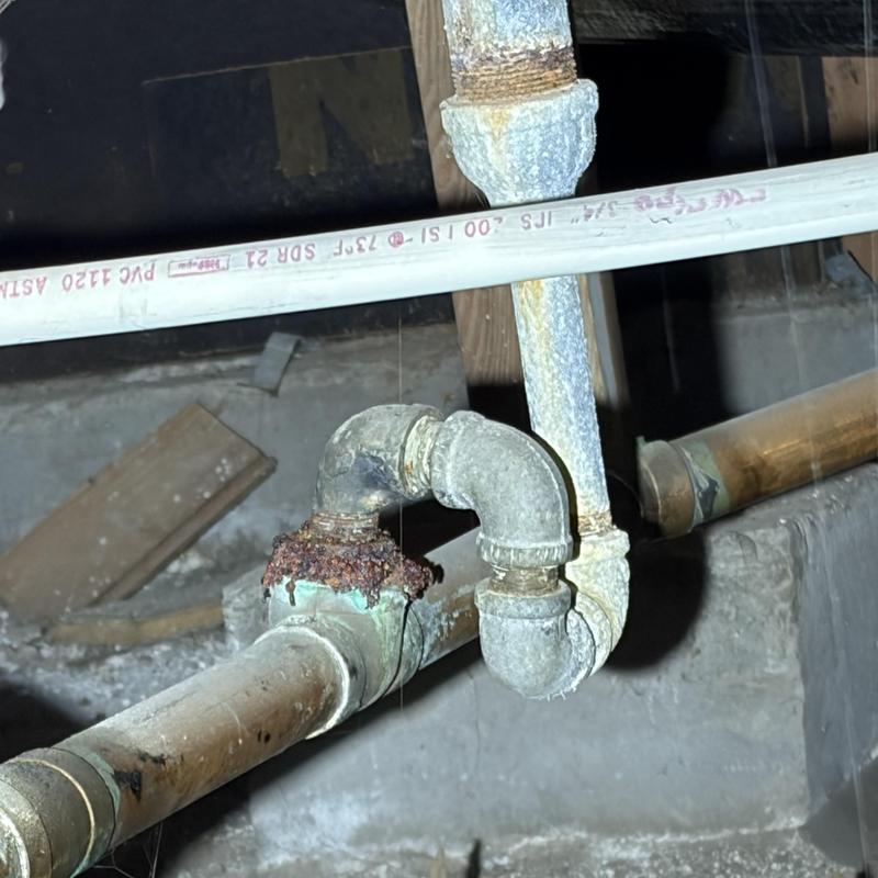 Cast iron drain line with rusted joint in crawlspace Cast iron drain line with rusted joint in crawlspace