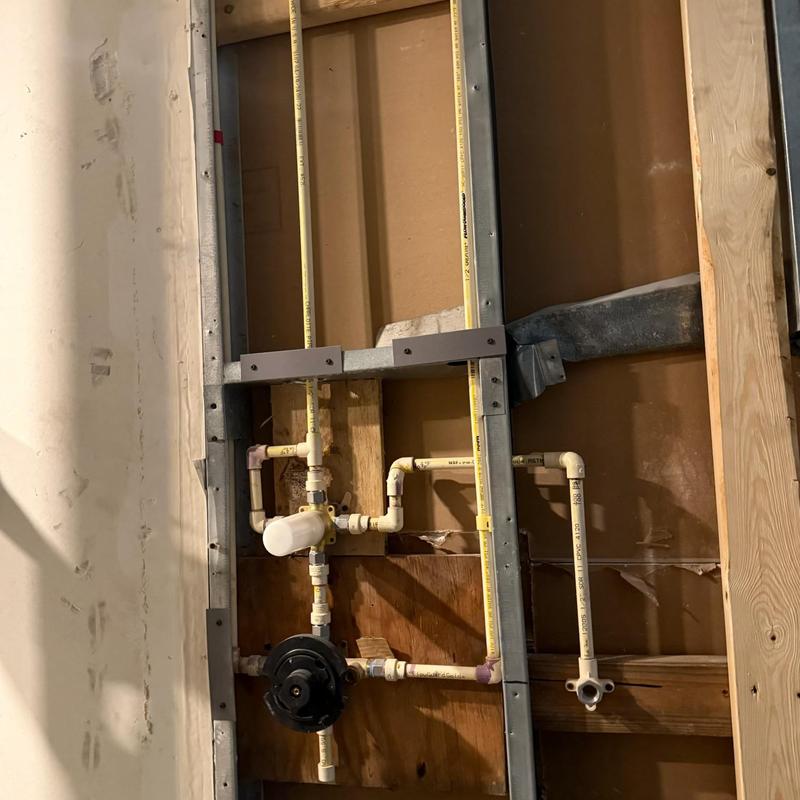 PVC plumbing rough-in with valve and framing