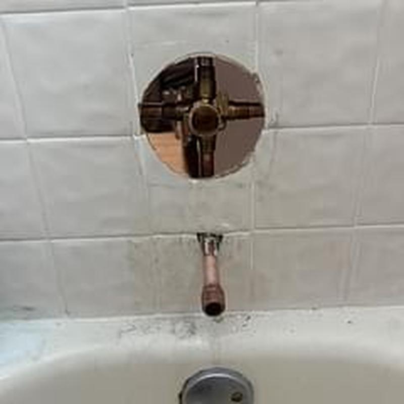Shower valve removal exposing copper plumbing behind tile wall