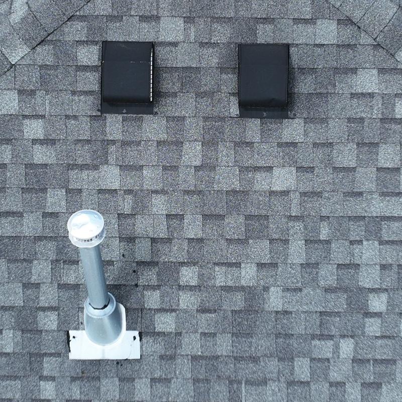 Roof shingles and plumbing vent pipe with hail damage