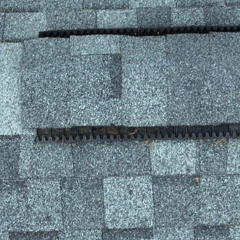 Asphalt roof shingles with hail damage and vents