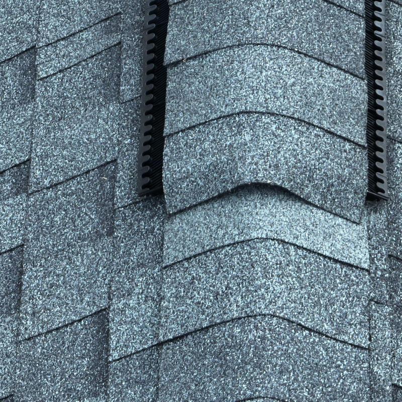 Asphalt shingle roof with visible hail damage close-up