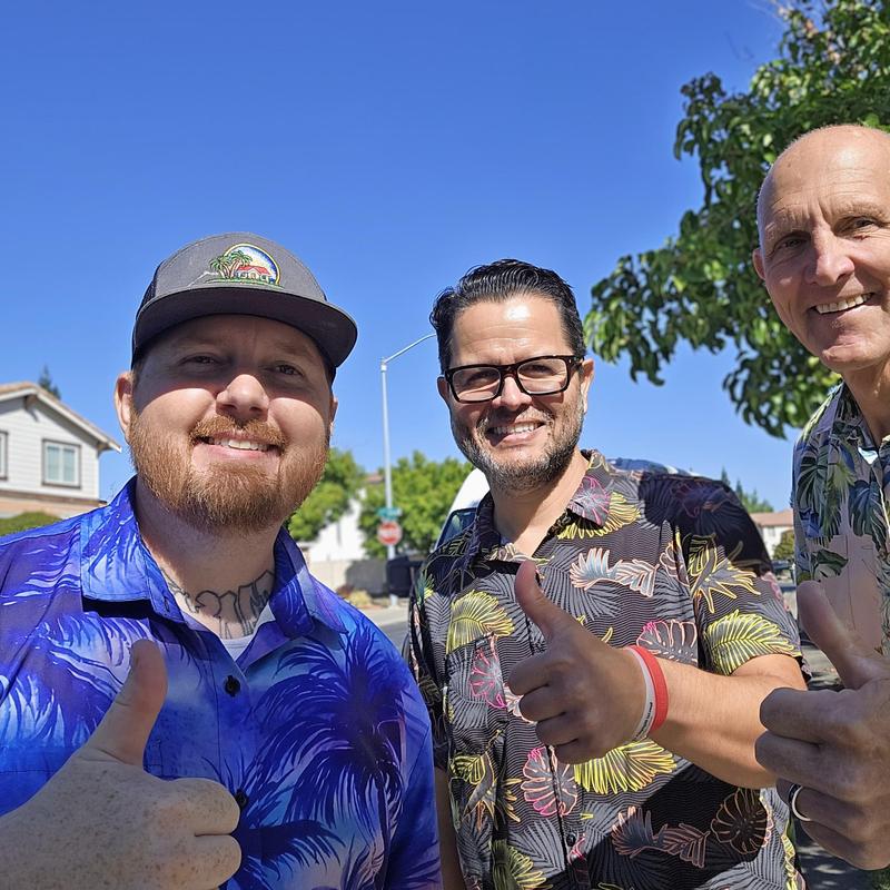 No specific system or item shown – three people giving thumbs up outdoors