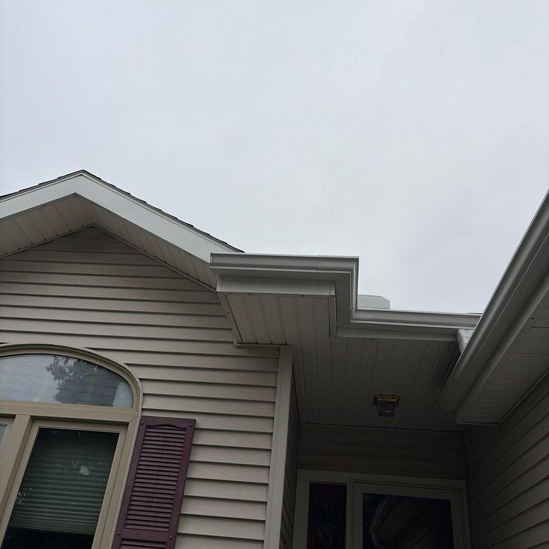 White metal gutters on gray vinyl siding home White metal gutters on gray vinyl siding home