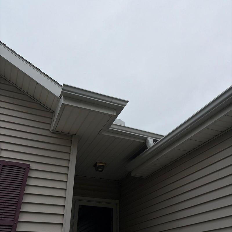 White rain gutters on house corner White rain gutters on house corner