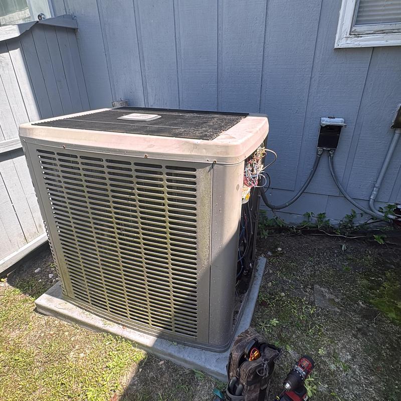 Air conditioner unit exterior with open panel maintenance