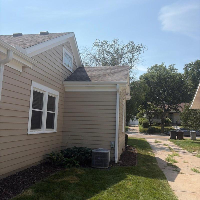 Gutter system on beige house exterior in Lincoln, NE Gutter system on beige house exterior in Lincoln, NE