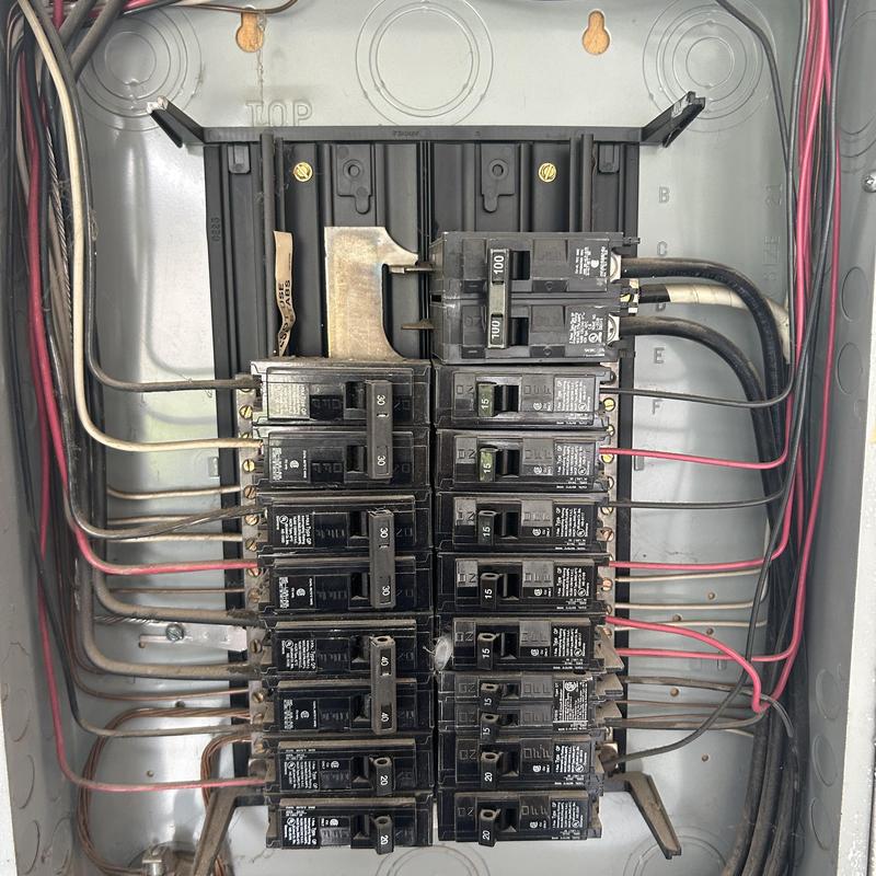 Electrical circuit breaker panel with multiple breakers and wiring Electrical circuit breaker panel with multiple breakers and wiring