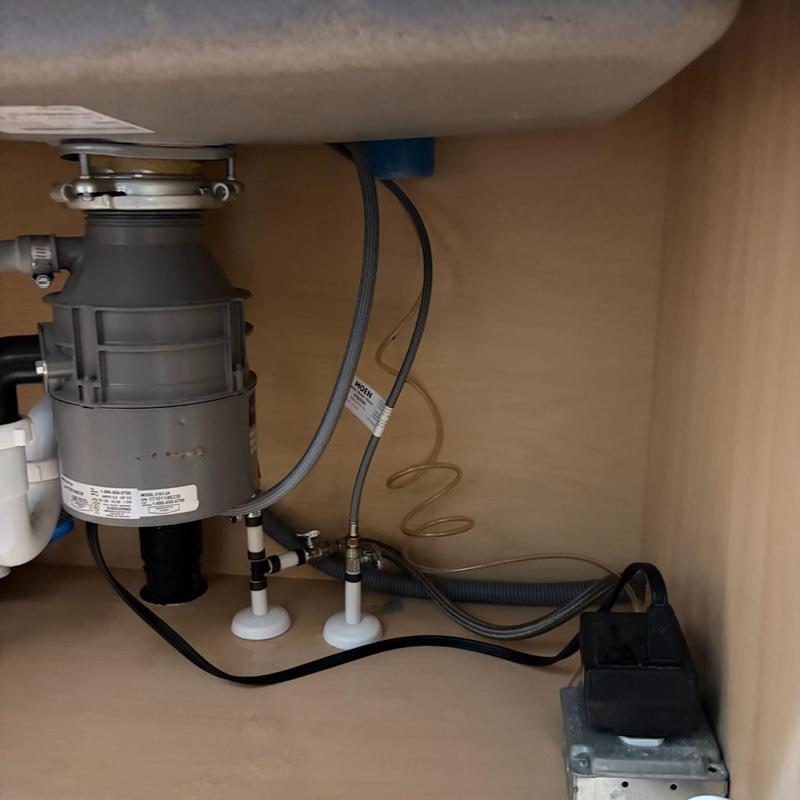 Sink disposal and Moen faucet plumbing installation under cabinet