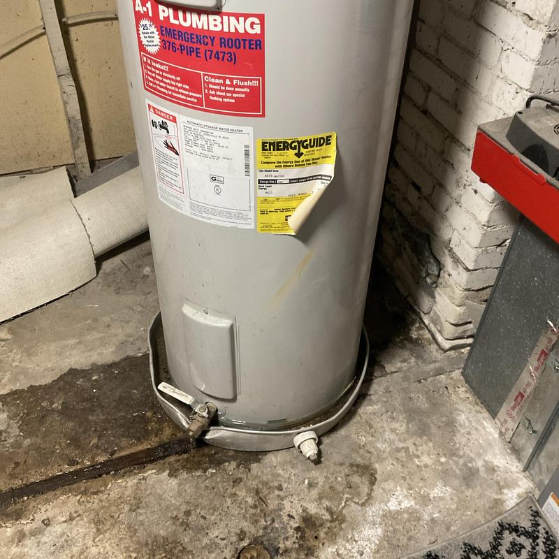 Water heater in basement with rusty drain pipe