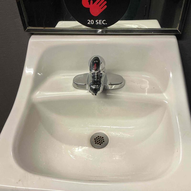 Center-set faucet installed on white sink basin