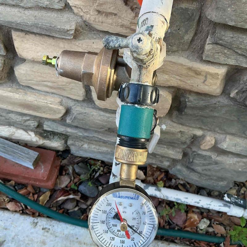 One-inch pressure regulator with pressure gauge installed outdoors