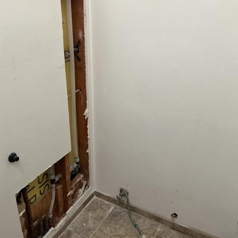 WirsboPEX water pipe installation behind drywall panel