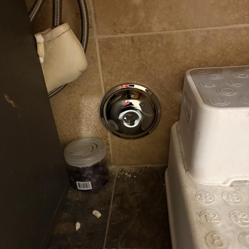 Cleanout cap with chrome beauty cover under sink