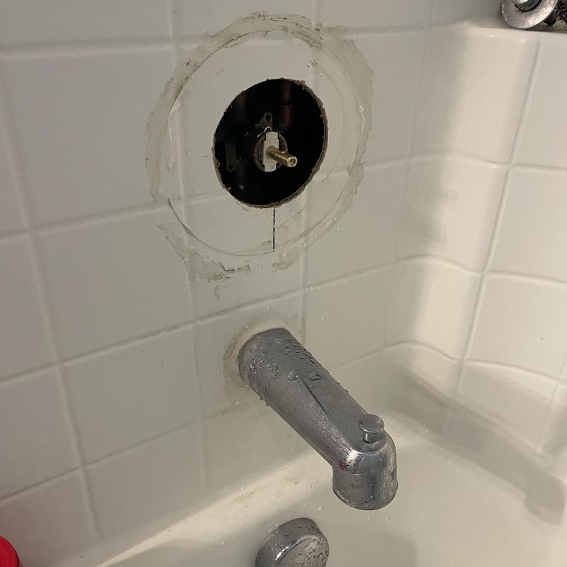 Shower valve with cartridge removed in tiled bathtub wall Shower valve with cartridge removed in tiled bathtub wall