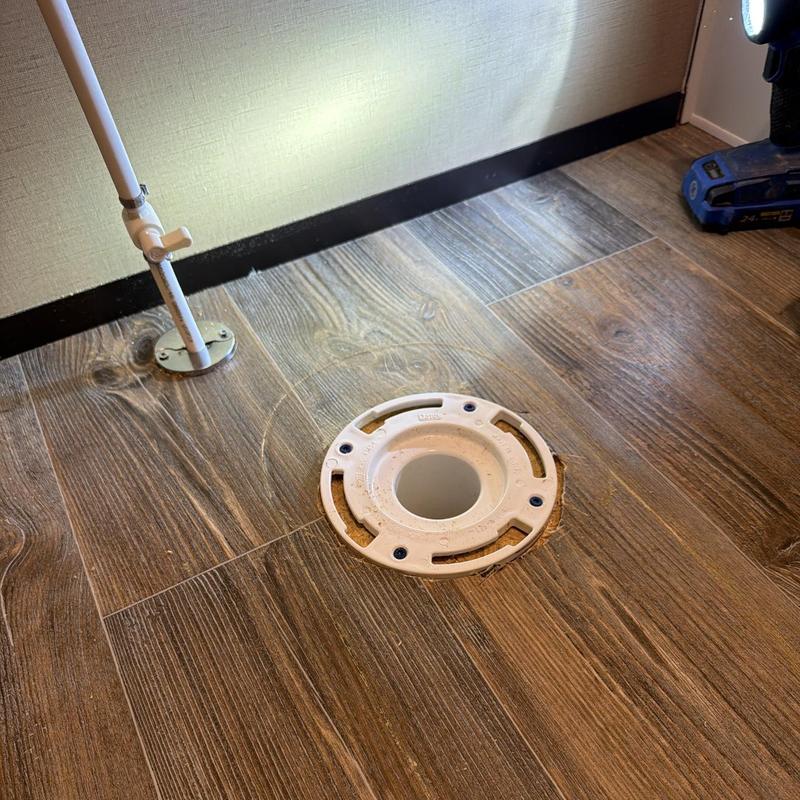 Toilet flange on wood floor cut and aligned