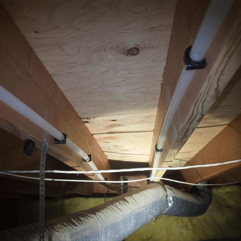 Pex piping installed in crawlspace under floor joists Pex piping installed in crawlspace under floor joists
