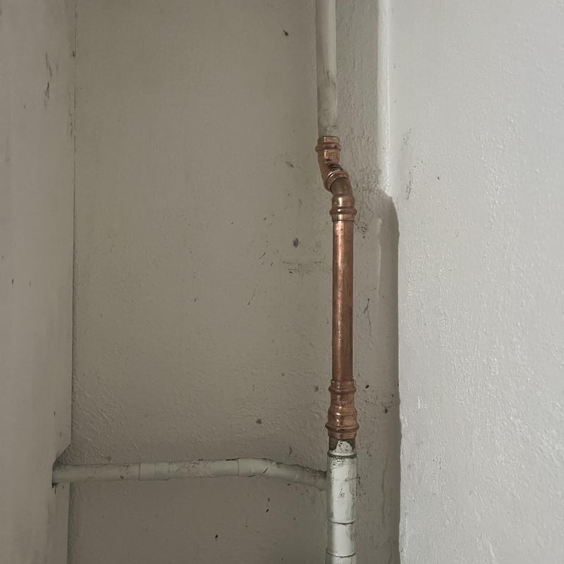 Copper water supply pipe with angled fittings in basement Copper water supply pipe with angled fittings in basement