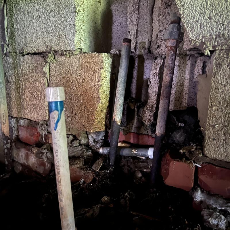 Water supply pipes in wall cavity with corrosion and damage Water supply pipes in wall cavity with corrosion and damage