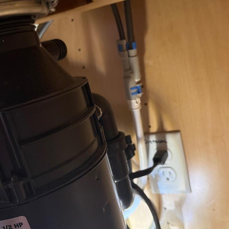 Garbage disposal under kitchen sink with power plug