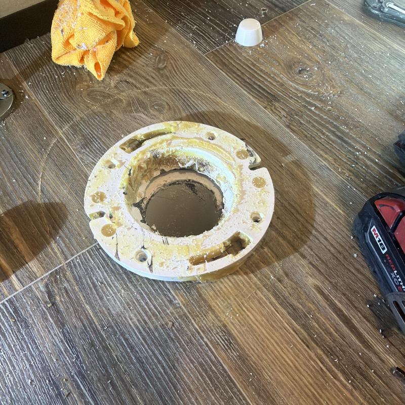 Toilet flange twisted repair with tools on floor