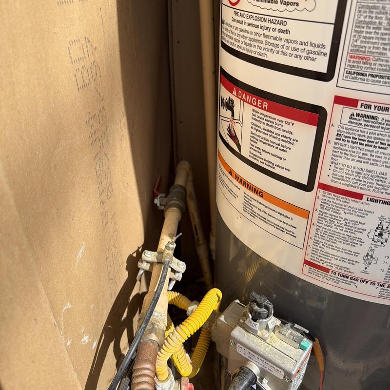 Gas water heater with connected natural gas line and valve