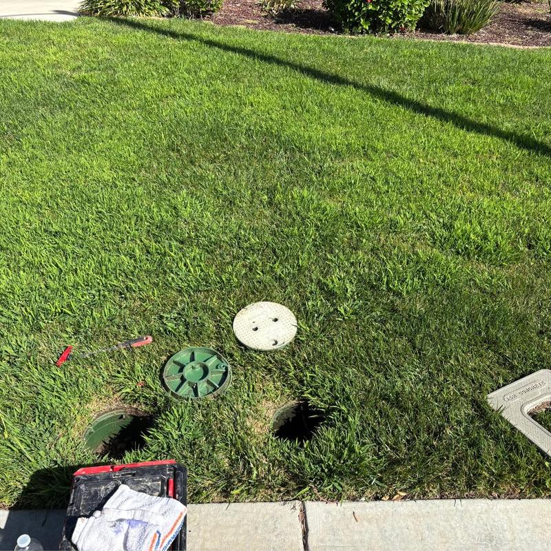 Main irrigation shut-off valve with tools on lawn Main irrigation shut-off valve with tools on lawn