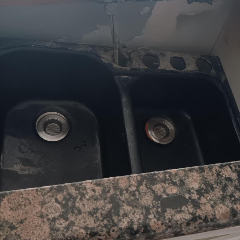 Double kitchen sink with missing faucet and drain fixtures Double kitchen sink with missing faucet and drain fixtures