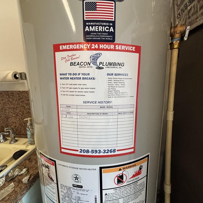 Water heater with Beacon Plumbing service label Water heater with Beacon Plumbing service label