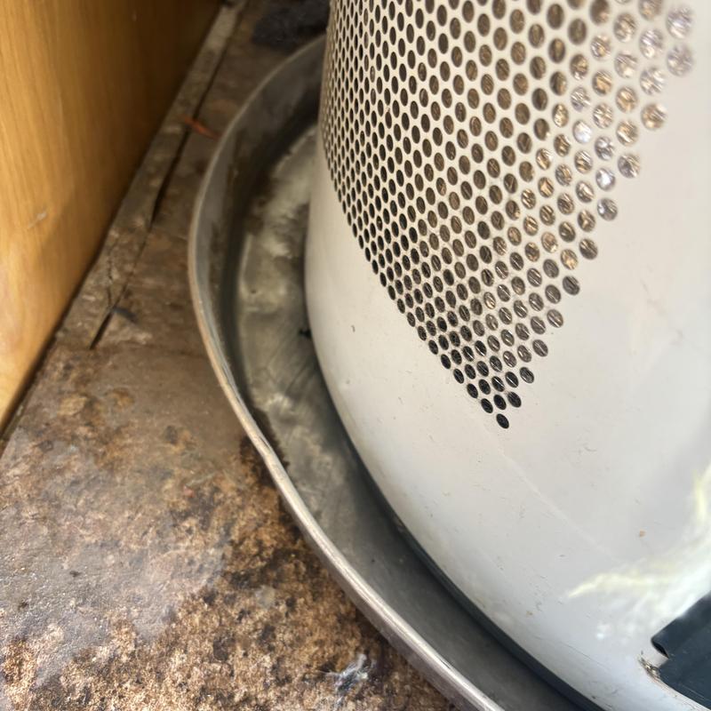 Water heater with leaking base pan inside cabinet Water heater with leaking base pan inside cabinet