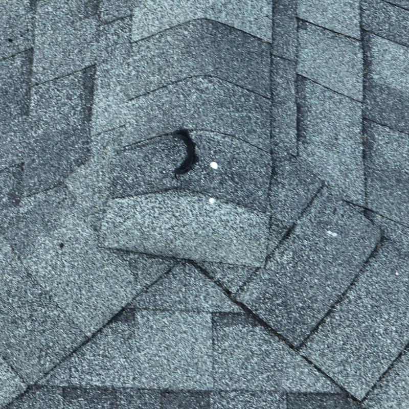 Roof shingles with hail damage and granule loss