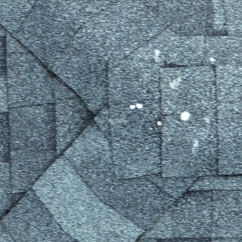 Asphalt shingle roofing with hail impact damage