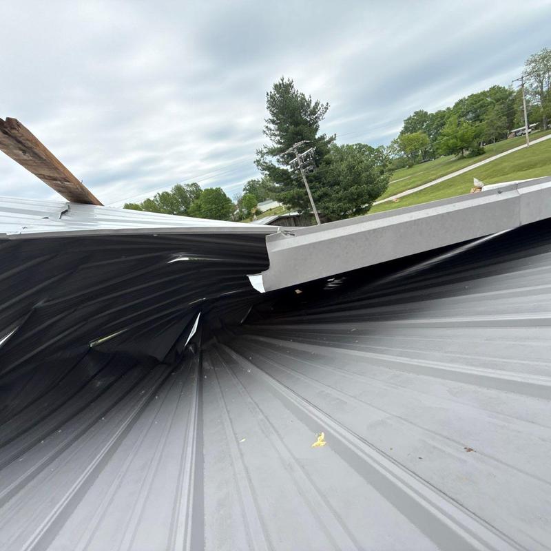 Metal roofing with severe warp and dent damage