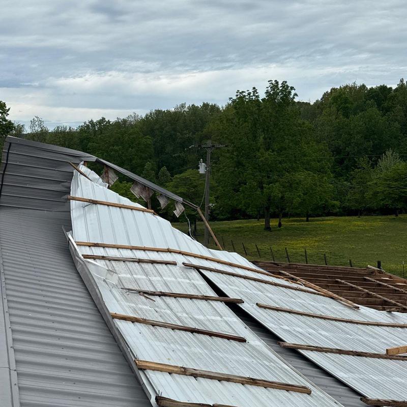 Metal roof panels with severe storm damage