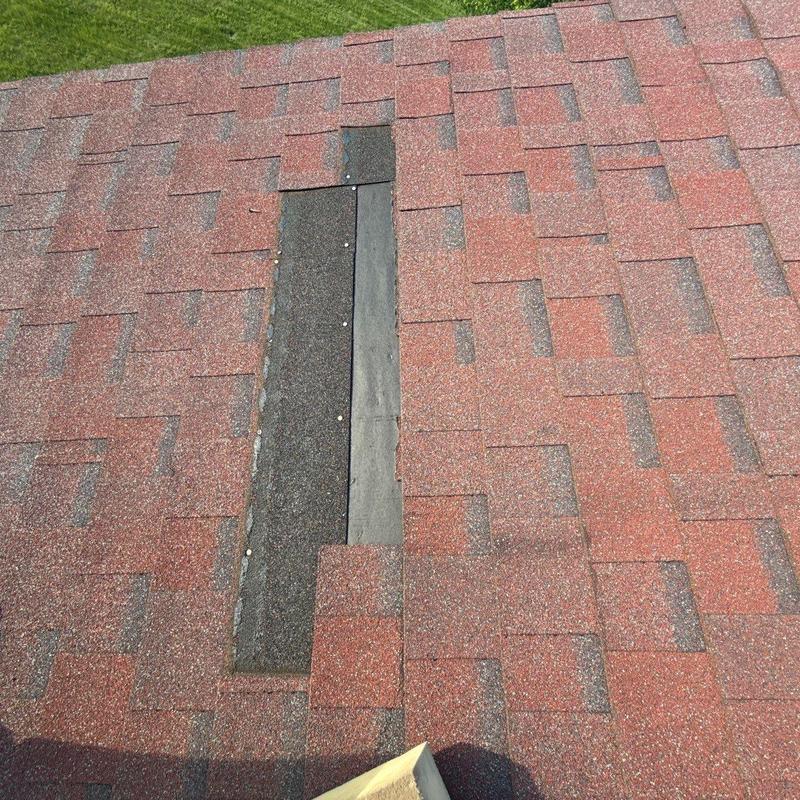 Roof shingles with hail damage and missing pieces